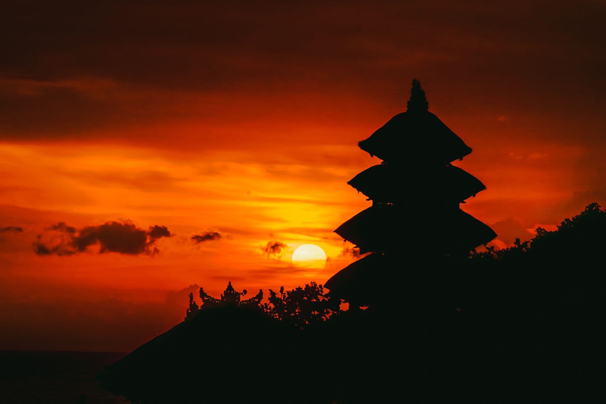 Temple silhouette against the setting sun near Tabanan