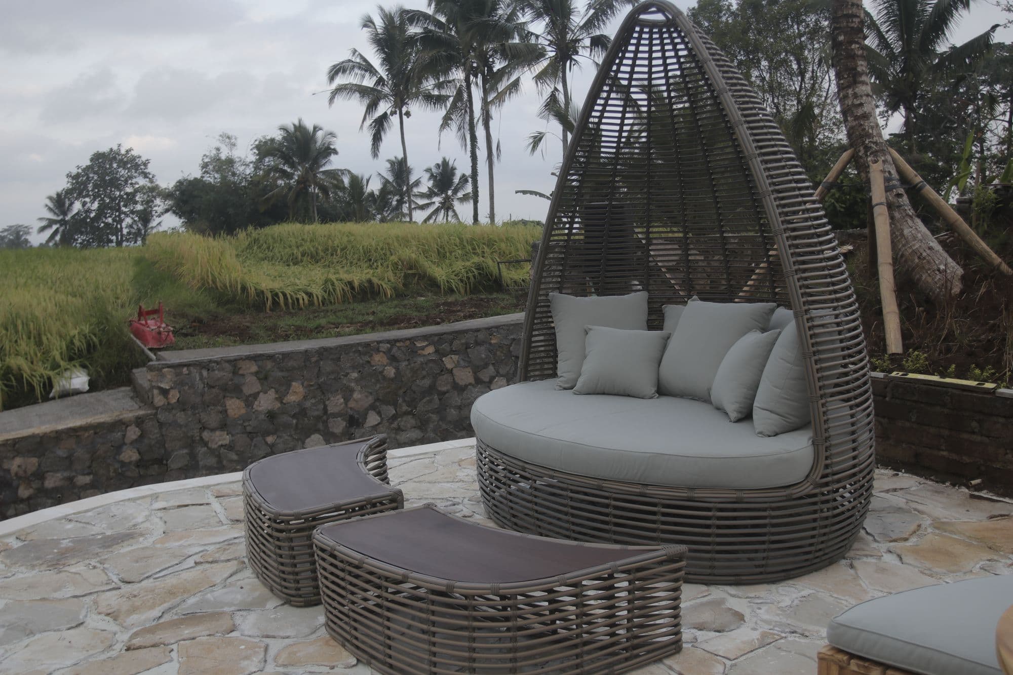 Rattan daybed on the stone terrace above the rice fields