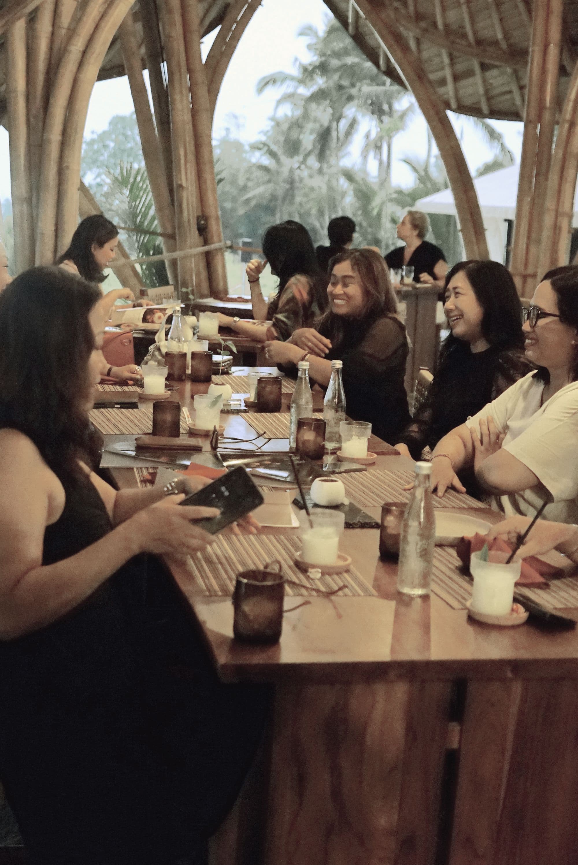 A group sharing dinner at a long wooden table